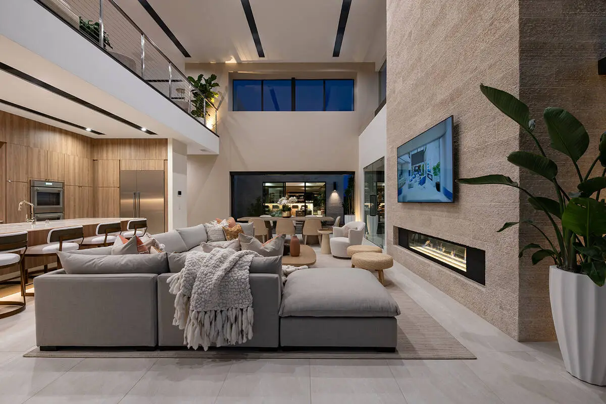 Double-height luxury living room with fireplace wall