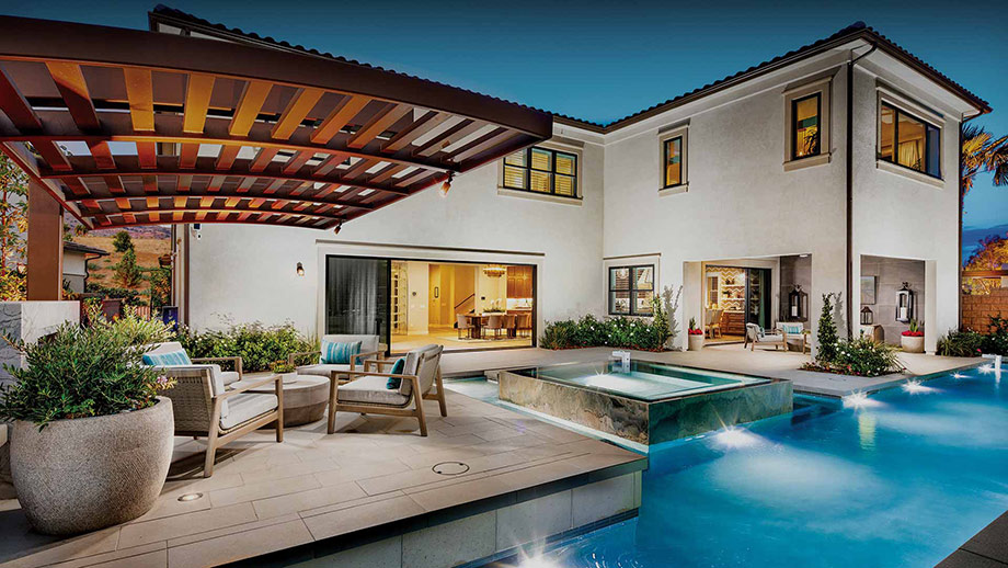 Luxury poolside patio at dusk with pergola and seating