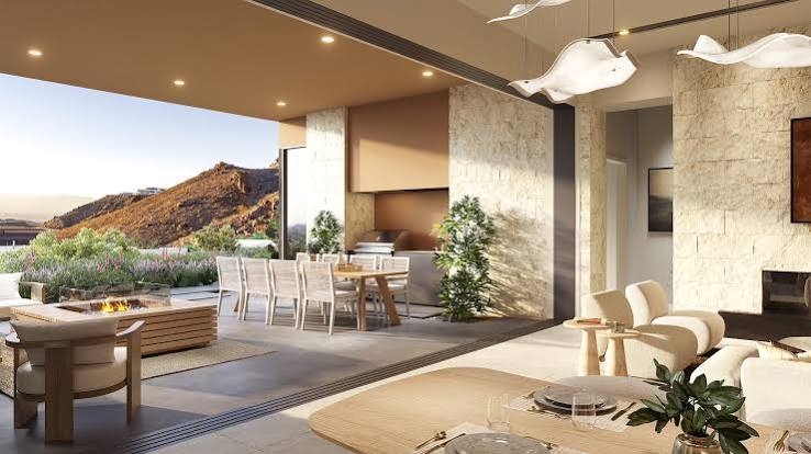 Covered outdoor dining patio with hillside views