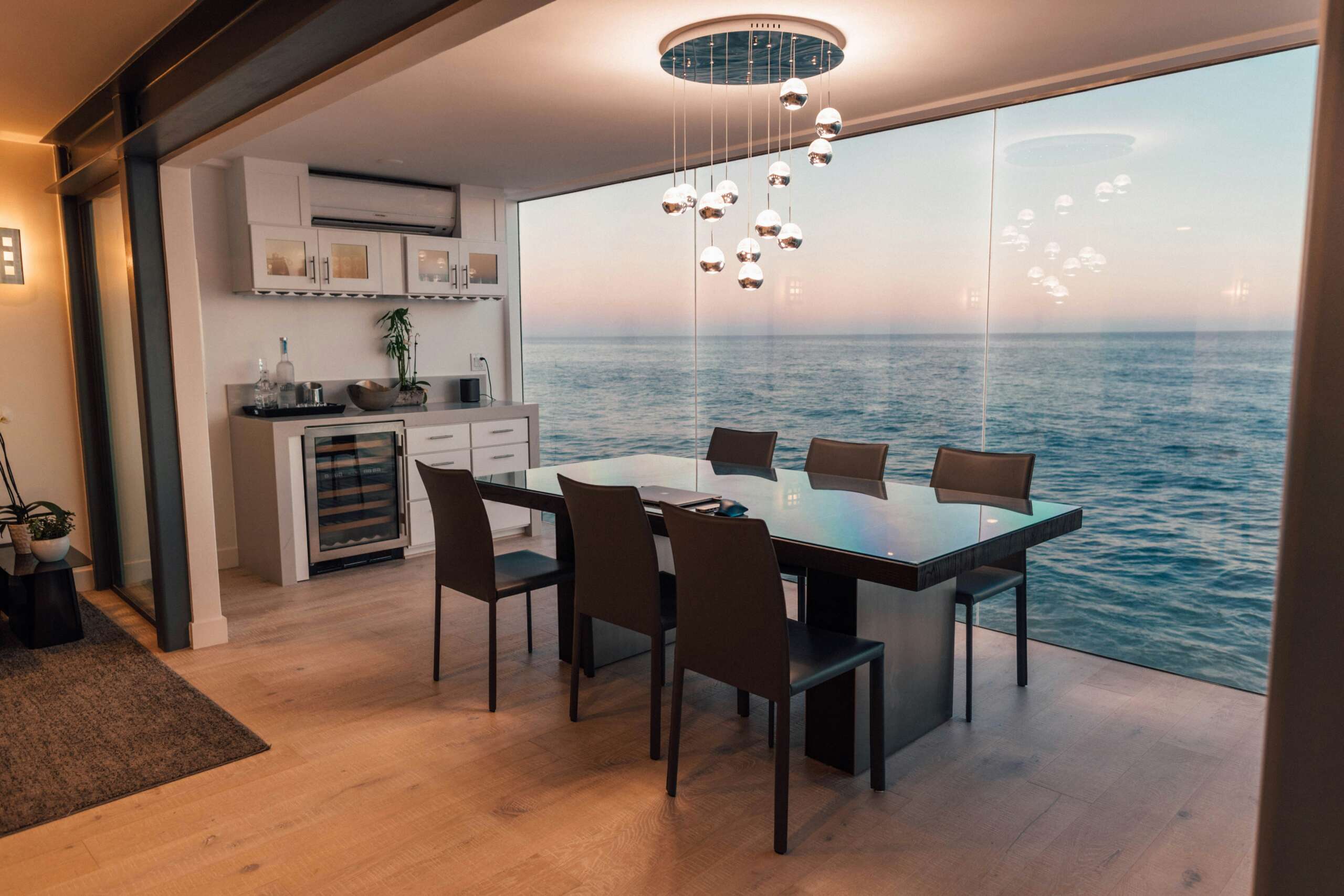 Oceanview dining and kitchen interior with pendant lighting